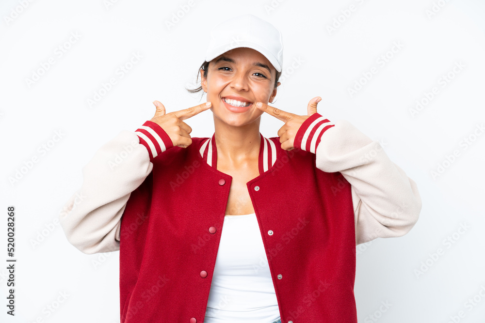 Young hispanic woman wearing a baseball uniform isolated on white background giving a thumbs up gesture Young hispanic woman wearing a baseball uniform isolated on white background giving a thumbs up gesture