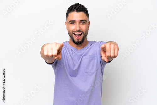 Young Arab handsome man isolated on white background surprised and pointing front