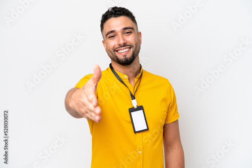 Young Arab man with ID card isolated on white background shaking hands for closing a good deal