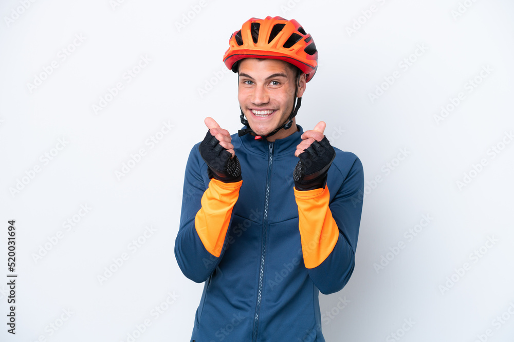 Young cyclist caucasian man isolated on white background making money gesture Young cyclist caucasian man isolated on white background making money gesture