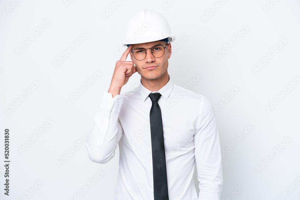 Young architect caucasian man with helmet and holding blueprints isolated on white background thinking an idea Young architect caucasian man with helmet and holding blueprints isolated on white background thinking an idea