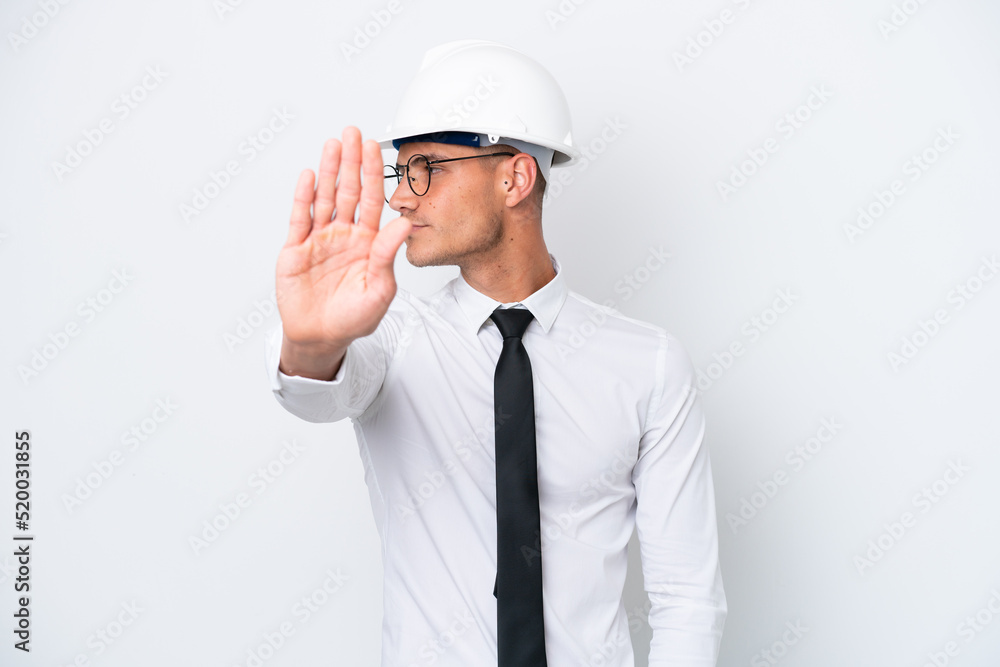 Young architect caucasian man with helmet and holding blueprints isolated on white background making stop gesture and disappointed Young architect caucasian man with helmet and holding blueprints isolated on white background making stop gesture and disappointed
