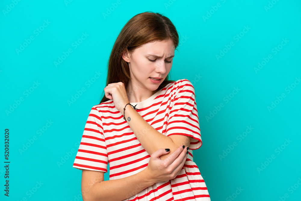 Young English woman isolated on blue background with pain in elbow Young English woman isolated on blue background with pain in elbow