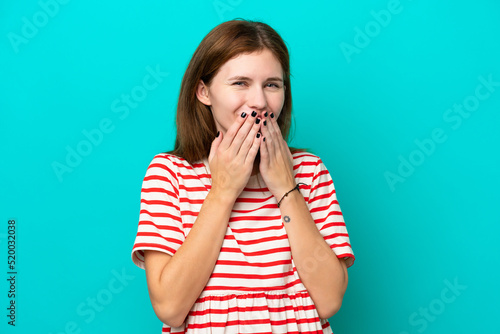 Young English woman isolated on blue background happy and smiling covering mouth with hands