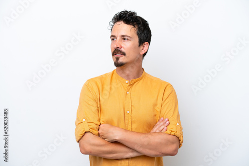 Young man with moustache isolated on white background looking to the side © luismolinero