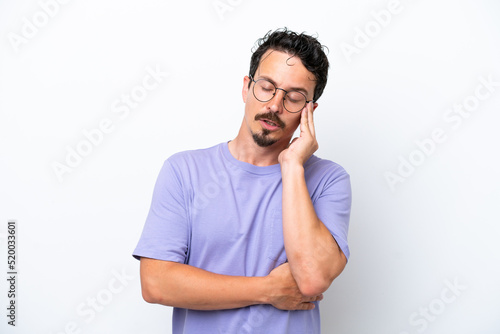 Young man with moustache isolated on white background with headache © luismolinero