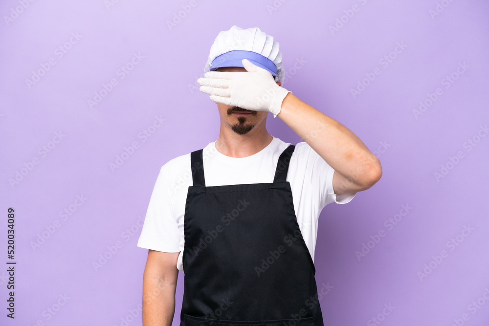 Fishmonger man wearing an apron isolated on purple background covering eyes by hands. Do not want to see something Fishmonger man wearing an apron isolated on purple background covering eyes by hands. Do not want to see something