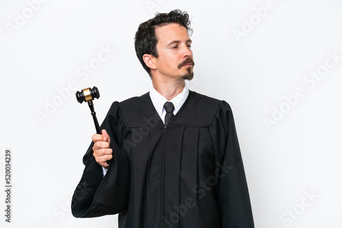 Young judge caucasian man isolated on white background looking to the side
