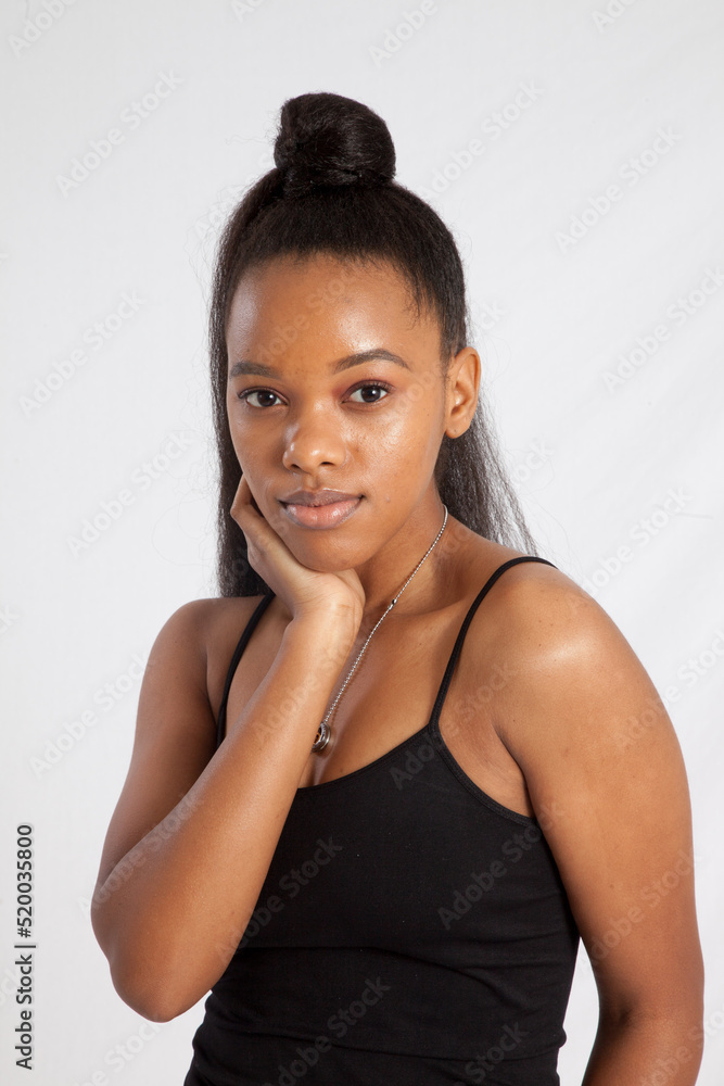 Beautiful woman with her hand to her face and a smile Beautiful woman with her hand to her face and a smile