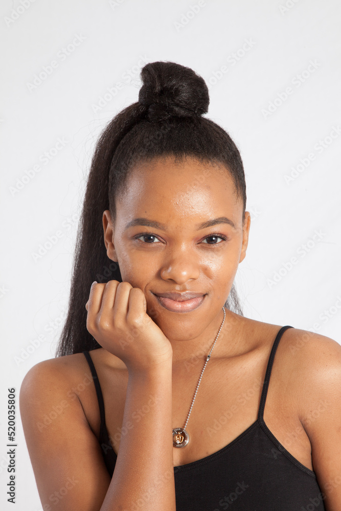 Beautiful woman with her hand to her face and a smile Beautiful woman with her hand to her face and a smile