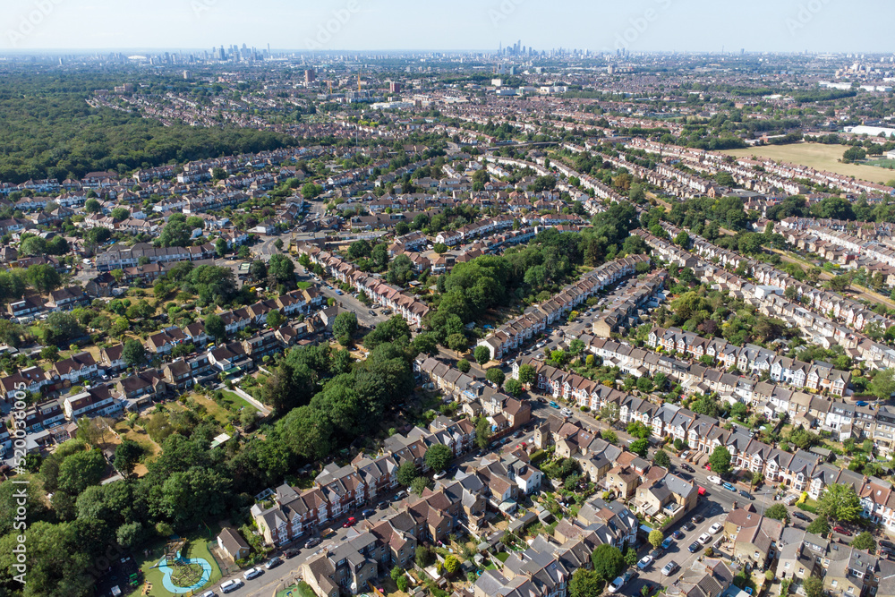 Aerial view Highams Park, a residential neighbourhood surrounded by forest and green parks on the outskirts of London. upmarket residential housings, and semi detached houses in the morning summer sun