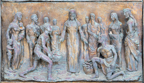 MONOPOLI, ITALY - MARCH 6, 2022: The bronze relief Miralce The Feeding the mu...