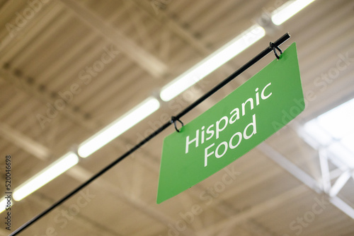 The sign for Hispanic Food section in a supermarket.