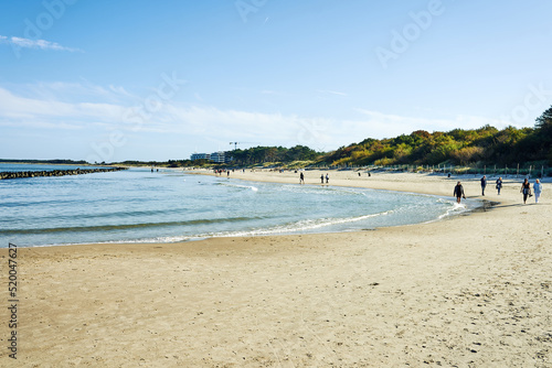 Beach, sea, people, pier and blue sky. Beach holiday.