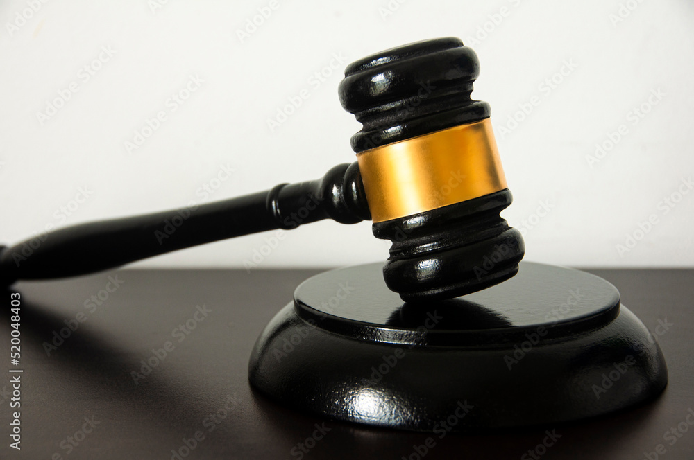 Straight view of lawyer gavel on wooden table with white background. Straight view of lawyer gavel on wooden table with white background.