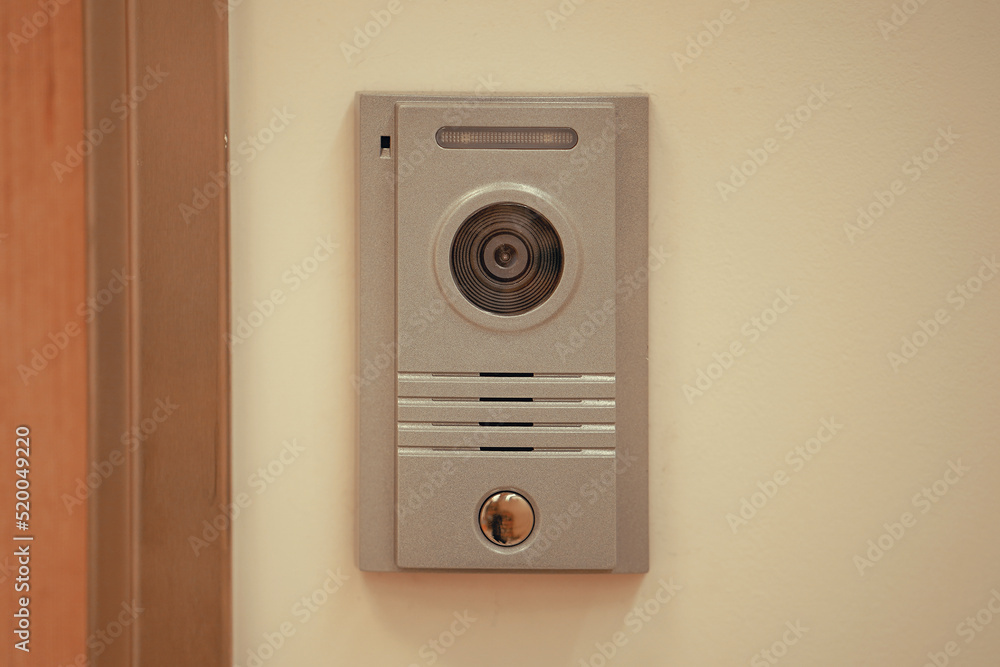 Video intercom system on white wall to enter office. Intercum with a camera in the office. New video intercom. Video intercom display on white wall near the entrance door Video intercom system on white wall to enter office. Intercum with a camera in the office. New video intercom. Video intercom display on white wall near the entrance door
