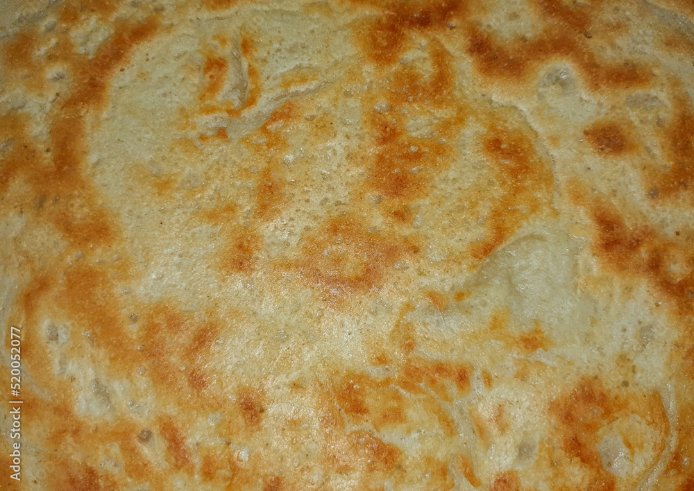 a close-up of a browned pancake a close-up of a browned pancake