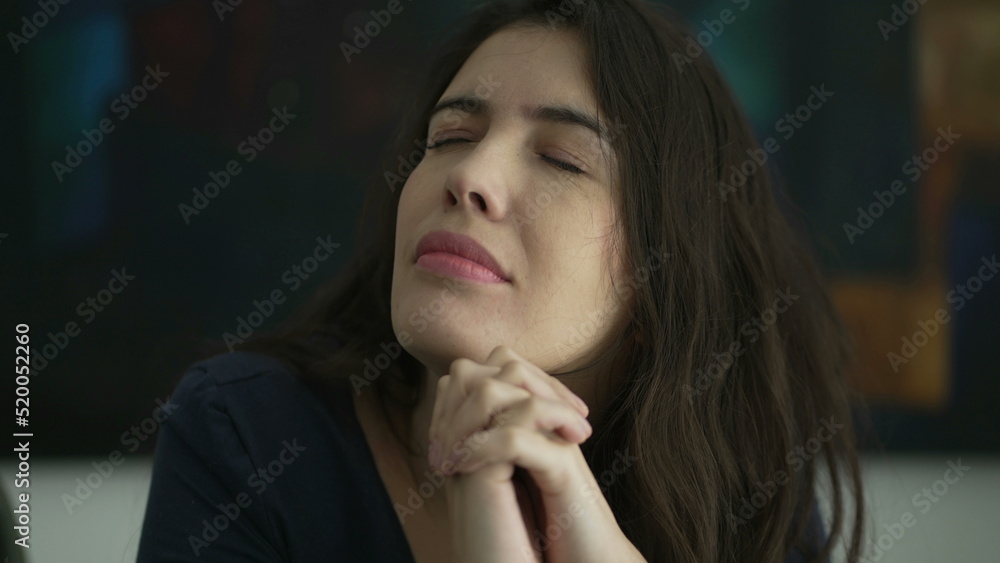 Woman with preoccupied expression closing eyes with regret. Person remembering past Woman with preoccupied expression closing eyes with regret. Person remembering past