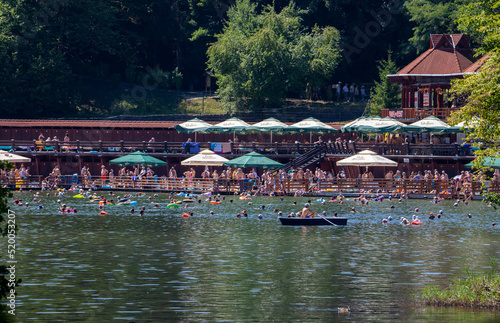 Tourists bathing in Bear lake from Sovata resort - Romania photo