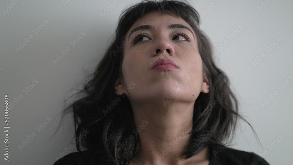 Close up woman face with frustrated emotion pondering solution to problem Close up woman face with frustrated emotion pondering solution to problem