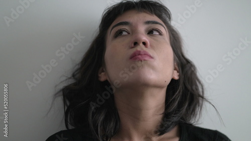 Close up woman face with frustrated emotion pondering solution to problem