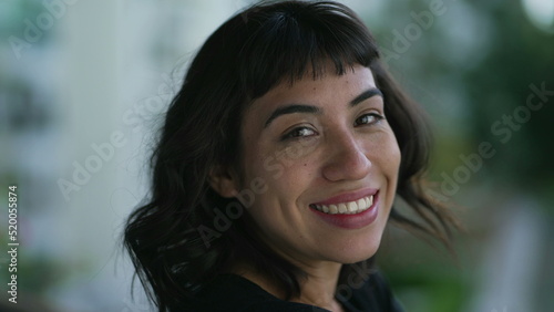 Portrait of a happy hispanic latin woman. Closeup of a South American Brazilian girl smiling at camera