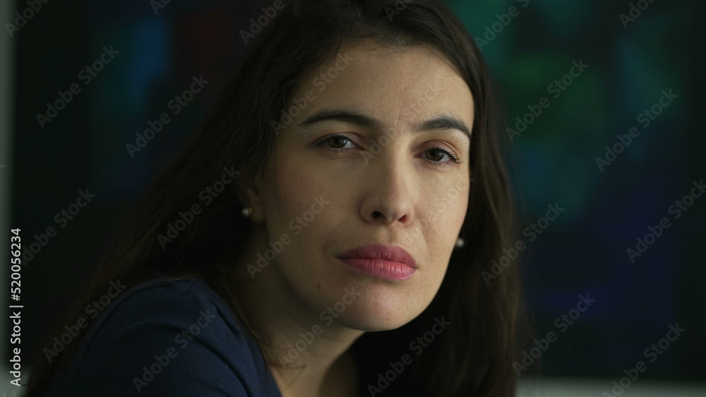 Fototapeta premium One thoughtful woman portrait face with serious expression looks at camera