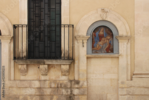 ancient building with religious paitning (pieta) in ragusa in sicily (italy) photo