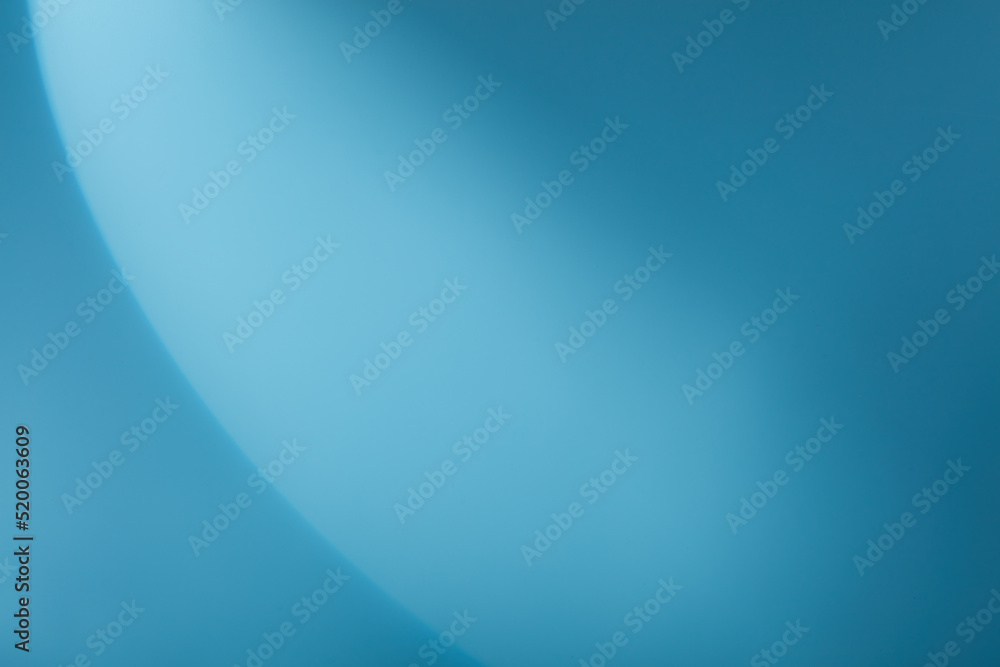 A semicircle of lights hits a light blue background
