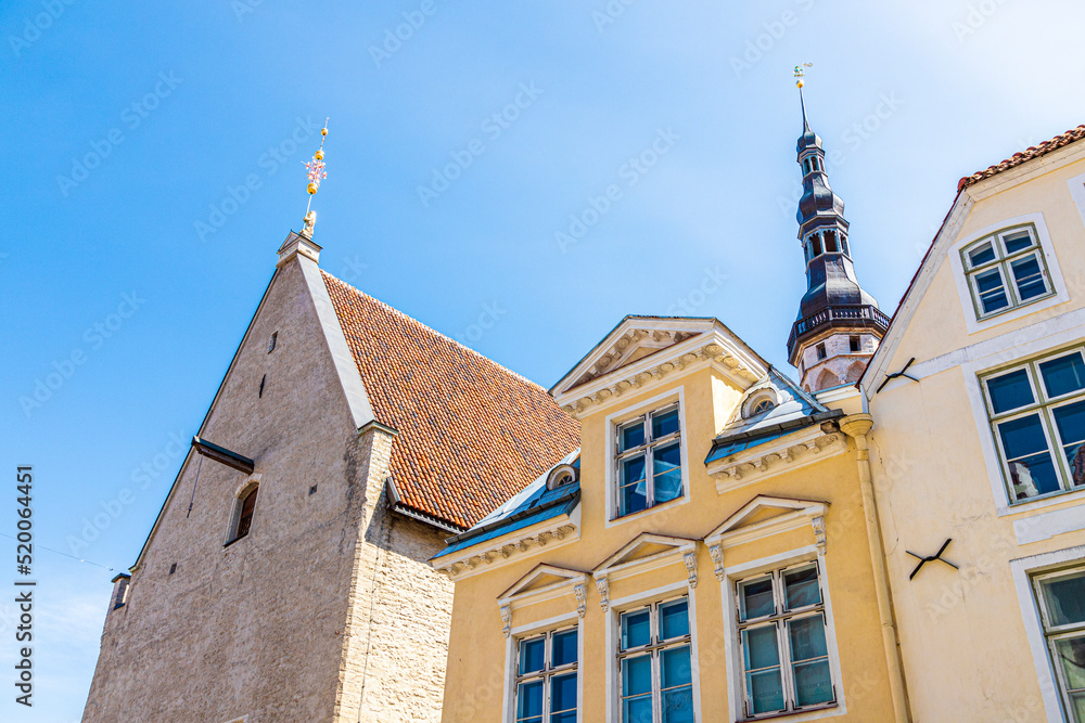 Rooflines including the Gothic tower and spire of the Town Hall (Tallinna raekoda) in the Old Town of Tallinn the capital city of Estonia