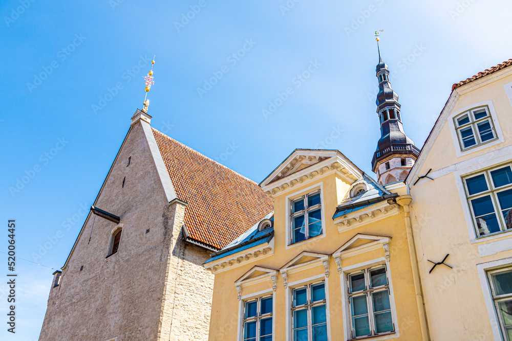 Fototapeta premium Rooflines including the Gothic tower and spire of the Town Hall (Tallinna raekoda) in the Old Town of Tallinn the capital city of Estonia