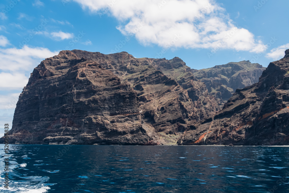 Panoramic view on the massive cliffs of Los Gigantes in Santiago del Teide, Western coast of Tenerife, Canary Islands, Spain, Europe. Rock formations along the coastline of the Atlantic Ocean. Freedom