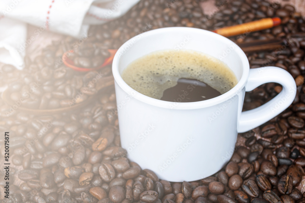 Cup of coffee on coffee beans and blurred background. Food and beverage concept. Cup of coffee on coffee beans and blurred background. Food and beverage concept.