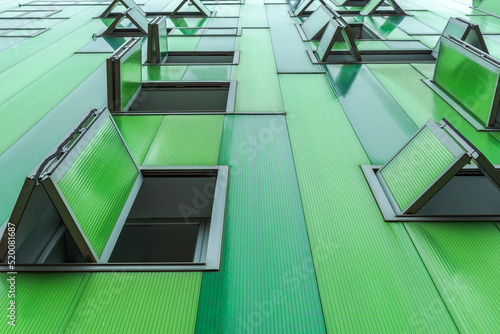 Modern green building with opened windows photo