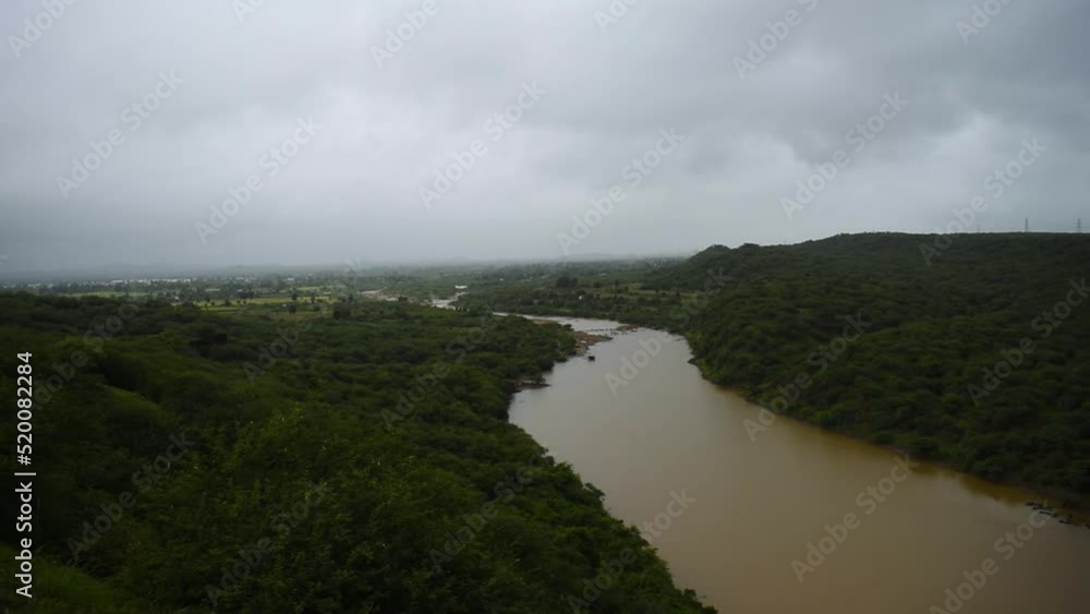 Beautiful view of muddy river flowing in between dense forest during monsoon at Kutch, Gujarat, India. Nature landscape. Beautiful view of muddy river flowing in between dense forest during monsoon at Kutch, Gujarat, India. Nature landscape.