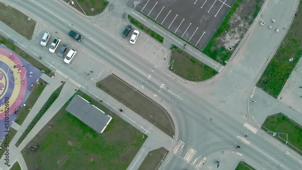 Drone view of the road and parking near a residential urban area. Life in the sleeping areas of European cities. Parking near the apartment complex. Road infrastructure of the sleeping area. Drone view of the road and parking near a residential urban area. Life in the sleeping areas of European cities. Parking near the apartment complex. Road infrastructure of the sleeping area.