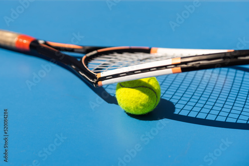 a broken tennis racket blue tennis court. © Angelov