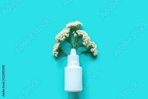 antihistamine drug flowers from nasal spray seasonal allergy concept on blue background photo