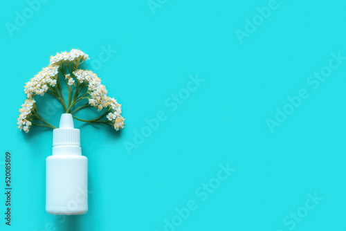 antihistamine drug nasal spray flowers concept seasonal allergy on blue background with space for text photo