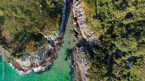 drone aerial view of the cantabric sea coast. Cliff on the coast with turquoise sea on a sunny summer day. photo
