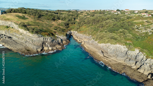 drone aerial view of the cantabric sea coast. Cliff on the coast with turquoise sea on a sunny summer day. photo