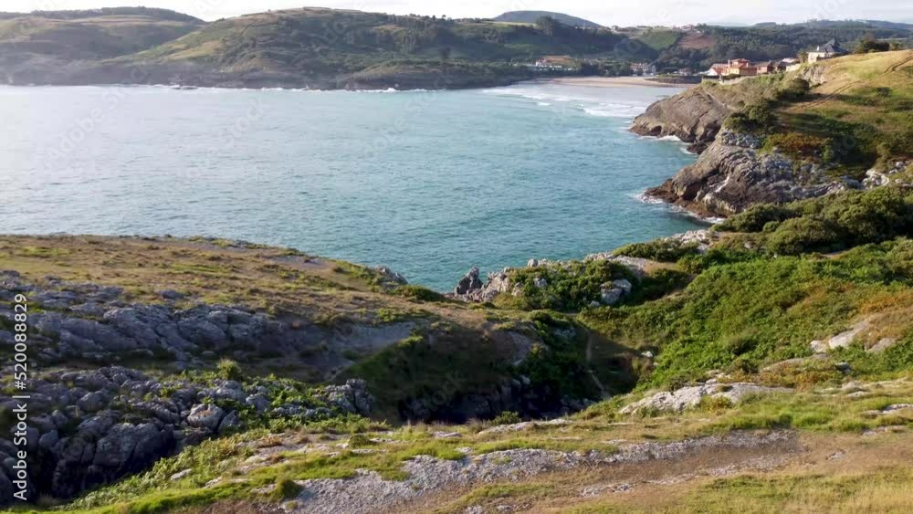aerial view with drone of the cantabrian coast with the sea entering and the village in the background with the beach on a sunny day. aerial view with drone of the cantabrian coast with the sea entering and the village in the background with the beach on a sunny day.