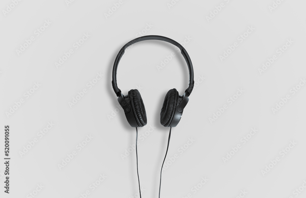 Computer headphones. Black headphones on a white background. The concept of listening to music, creating audio, music. Computer work, abstraction and minimalist style. Computer headphones. Black headphones on a white background. The concept of listening to music, creating audio, music. Computer work, abstraction and minimalist style.