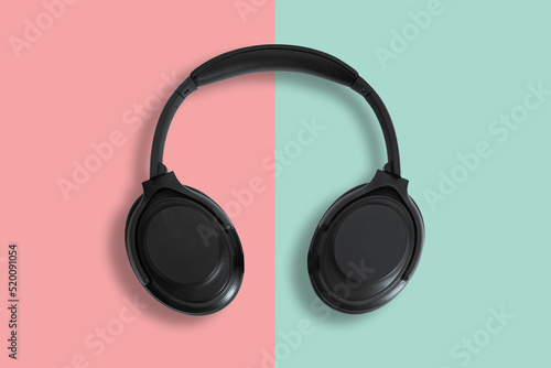 Computer headphones. Black headphones on a white background. The concept of listening to music, creating audio, music. Computer work, abstraction and minimalist style.