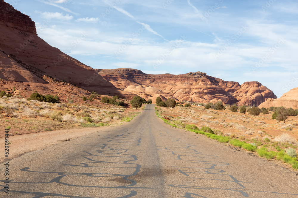 Scenic Road in the Dry Desert with Red Rocky Mountains in Background. Scenic Road in the Dry Desert with Red Rocky Mountains in Background.