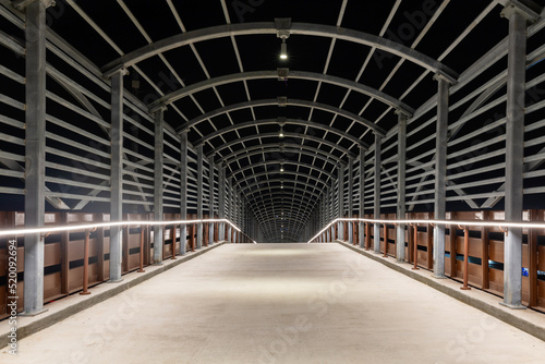an eerie passageway of steel and light