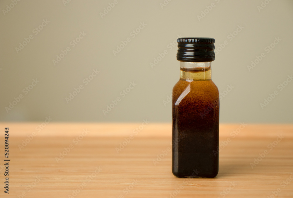 Bottle of oil on a wooden table Bottle of oil on a wooden table