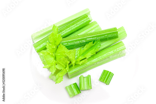 Fresh Chopped Celery Sticks and Slices with Leaves and Water Drops Isolated on White Background. Vegan and Vegetarian Culture. Raw Food. Healthy Diet with Negative Calorie Content