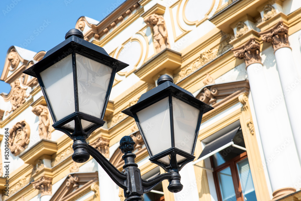 old metal lantern on the background of a house in a European city old metal lantern on the background of a house in a European city
