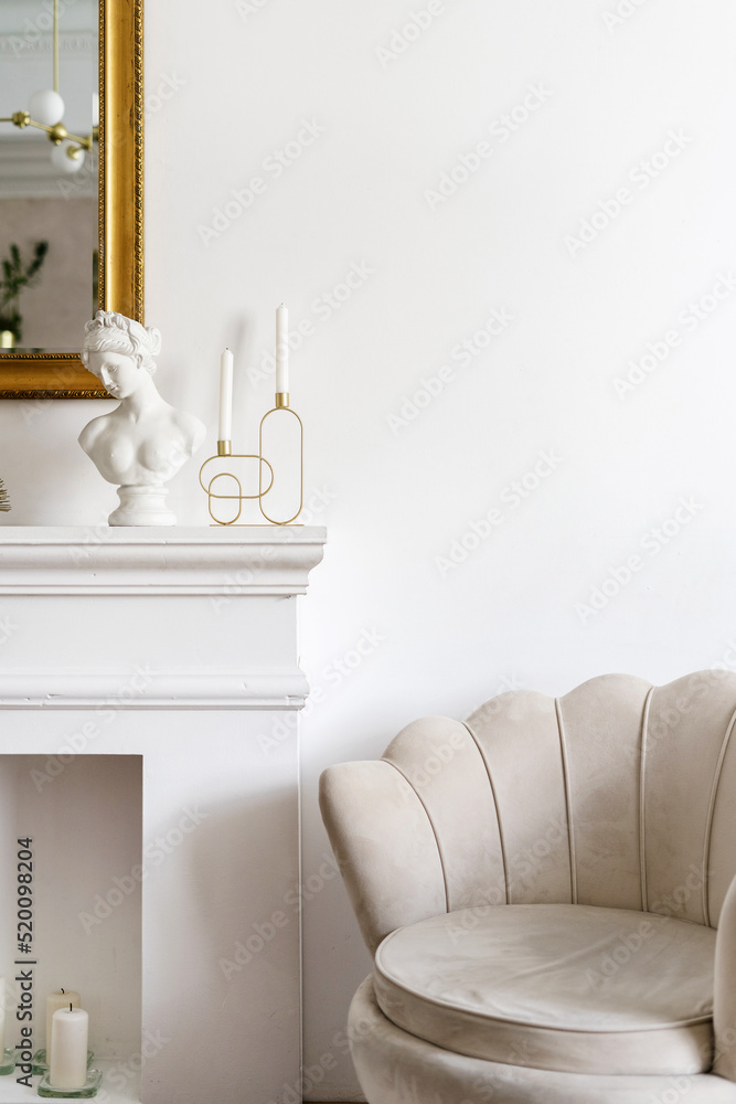 Fototapeta premium Beige armchair and decorative fireplace in living room